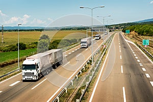 White Lorry trucks in line on a country highway