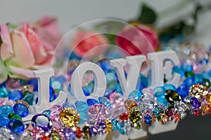 White love letter inside colorful diamonds.