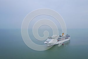 White luxury cruise ship docked in beautiful Caribbean sea close