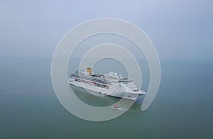 White luxury cruise ship docked in beautiful Caribbean sea close