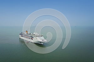 White luxury cruise ship docked in beautiful Caribbean sea close