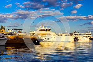 White luxury yachts in a sea harbor of Hurghada, Egypt. Marina with tourist boats on Red Sea