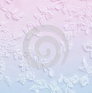 White lwedding lace with decorative embroidery background in blue and pink colors