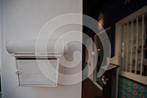 A white mailbox is mounted on a wall