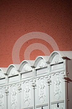 White mailboxes on an orange wall