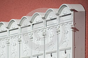 White mailboxes on an orange wall