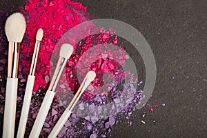 White make up brushes and violet and pink eyeshadows