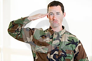 White male in army uniform saluting