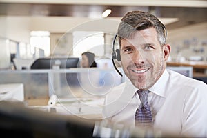 White male call centre worker smiling to camera