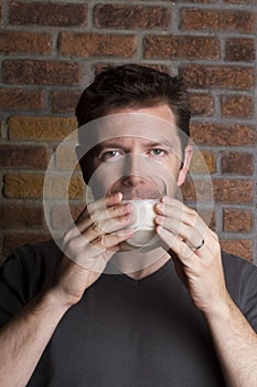 White male drinking glass of milk