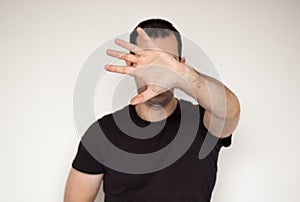 White male man ignore stop concept leave me allone not listen black tshirt hand photo