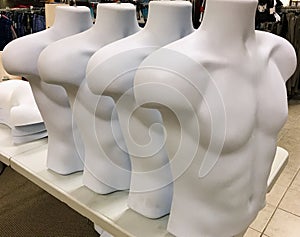 White male mannequin torsos in a row