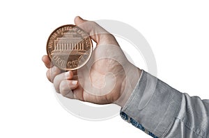 White man in blue shirt hold a big american penny one cent in his hand.  on white background