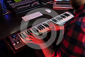 White man compositor is playing on keyboard in the record studio for radio fm photo