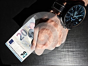 White man`s hand holds a bank note, keep money, money in the palm of your hand, receive money, give money, watch on hand, Europea