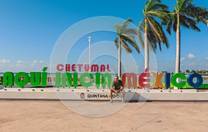 White Man Tourist near the Colorful Stone letters with Chetumal name and Palm Trees