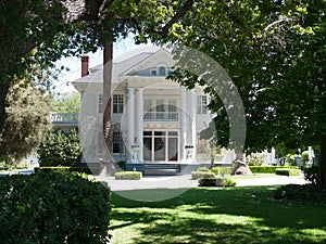 White mansion in park like setting