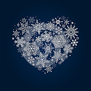 White many snowflakes in the shape of a herat on dark blue background. Vector lace banner