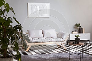 White map on grey wall in fashionable living room interior with scandinavian futon photo