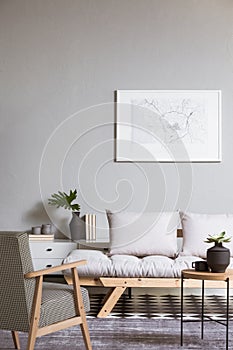 Map on grey wall in fashionable living room interior with scandinavian futon photo