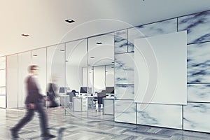 White marble and glass company lobby, people