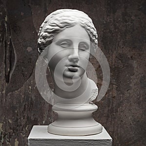 White marble head of young woman. Statue art sculpture of stone face. Ancient beautiful woman monument photo