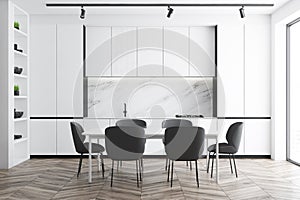 White and marble kitchen interior with table