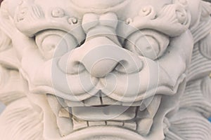 White marble lion statue stand in Chinese temple, Thailand