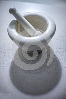 White Marble Mortar And Pestle On Light Surface