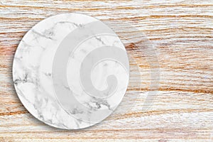 White marble plate placed on wood.