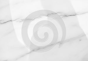 White marble surface with subtle grey veining and a smooth,