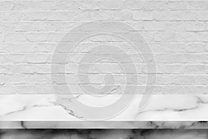 White marble table with brick wall background.