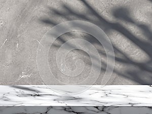 White Marble Table with Tree Shadow on Concrete Wall Texture Background