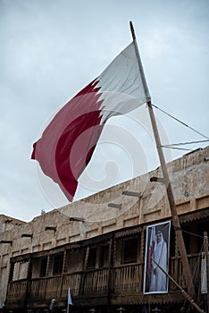 White and maroon Qatari flag at a Middle Eastern souvenir shop