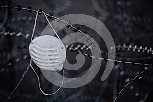 White mask on barbed wire