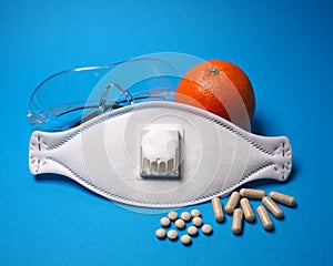 White mask with glasses and vitamines against virus, corona or flu photo