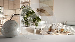 White mat table shelf with round marble vase and potted bonsai, green leaves, over wooden living room with sofa, teatime, modern