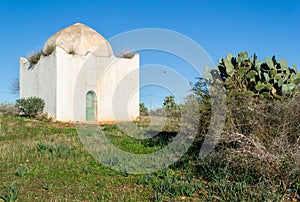 White mausoleum with dome and islamic architecture