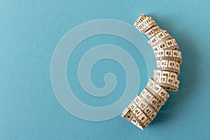 White measuring tape on a blue background. Close-up