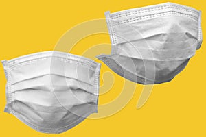 white medical face mask isolated on yellow background with clipping path