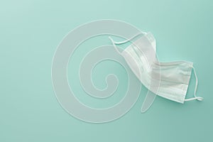 White medical mask isolated, sky blue background.