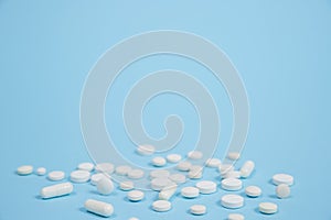 White medical pills on blue background