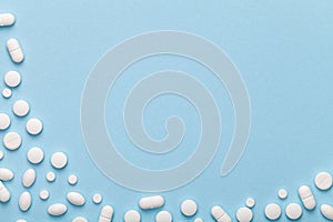 White Medical Pills on Blue Background