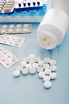 White medical pills and tablets spilling out of a bottle. Mock up bottles with copy space