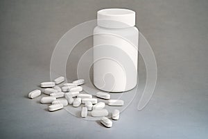 White medicine bottle and pills