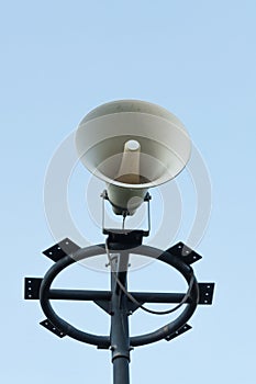 White megaphone on the old pole