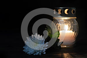 White memorial candle and flower