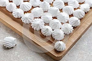 White Meringues on the wooden tray