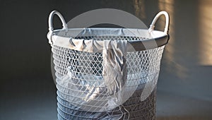 Photorealistic image of a white mesh laundry hamper