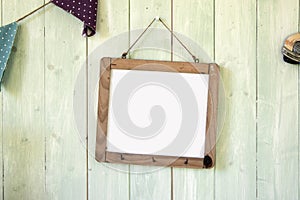 White message board hanging on retro green wooden wall